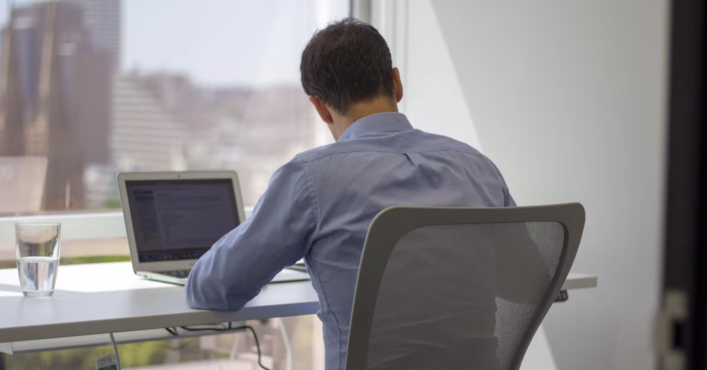A person working at a laptop beside the window at Clarence, 111 Elizabeth Street.